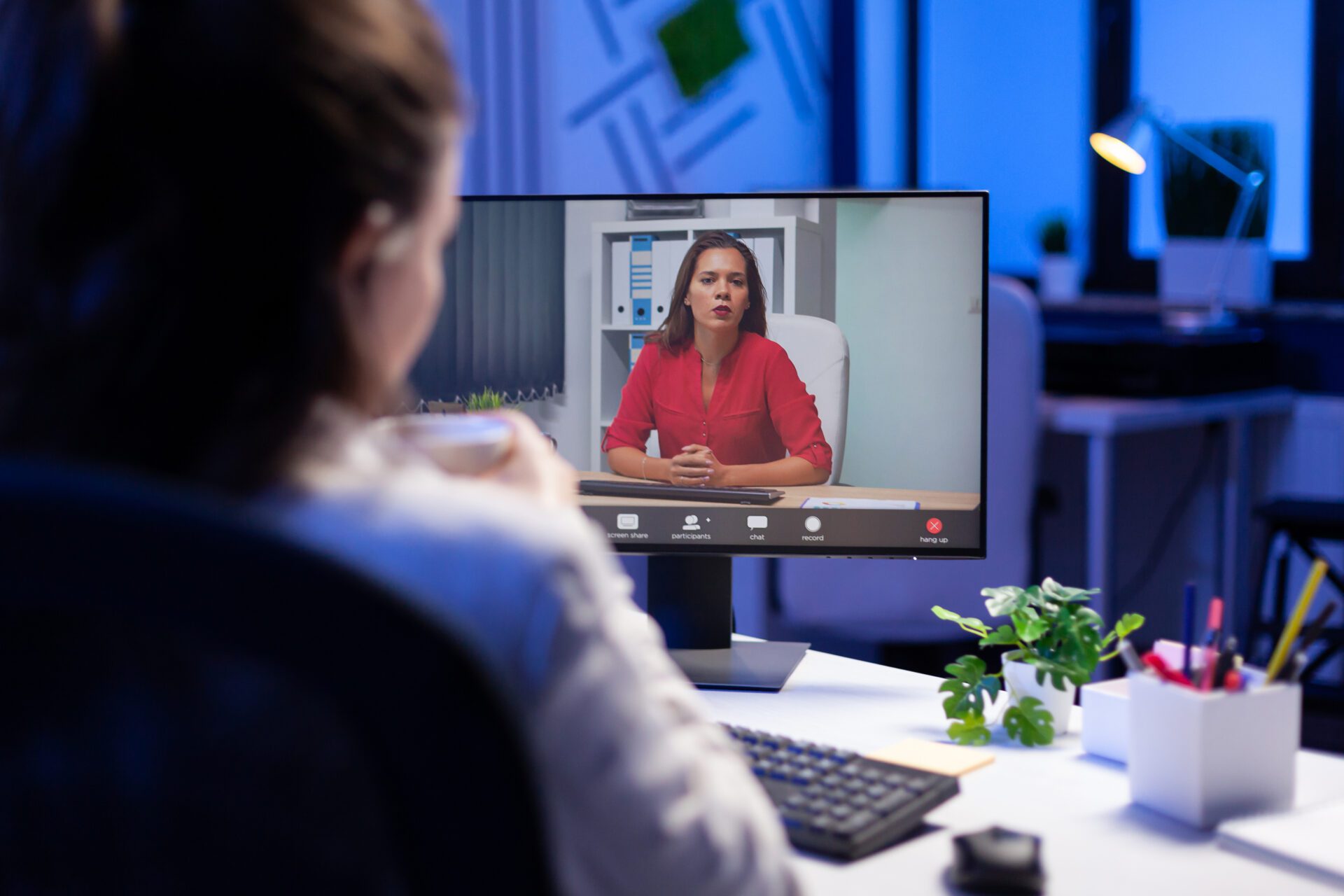 Manager talking with teamates during online teleconference Manager talking with teamates during online teleconference